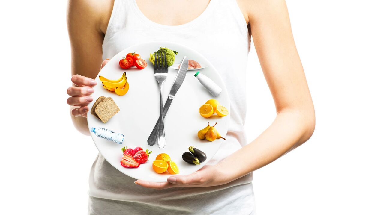 The girl holds a plate with food